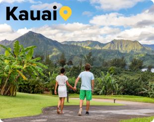 Couple walking with Mountains in the background on Kauai Hawaii