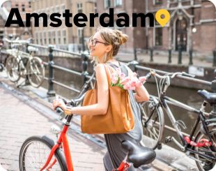 Lady biking along the channel in Amsterdam 