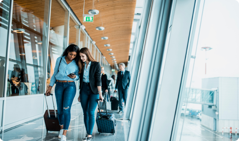 two friends walking together through an airport