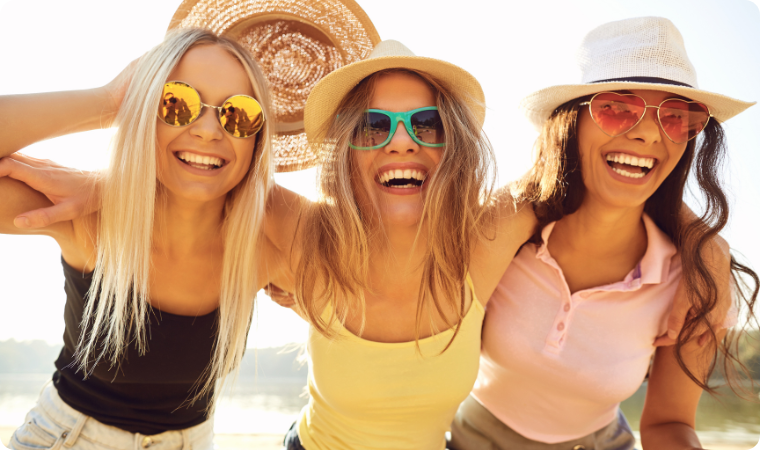 girl friends laughing together at the beach