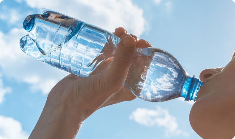 lady drinking from a clear water bottle