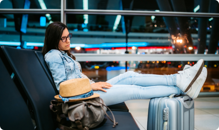 lady napping whilst sitting at the airport